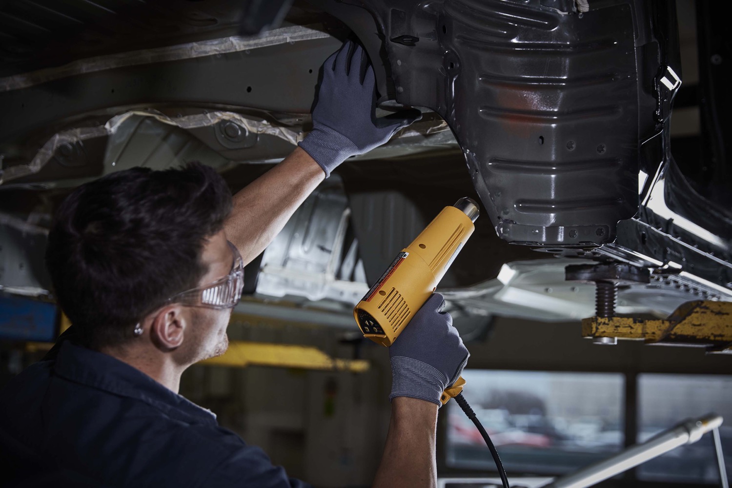 Automotive service technician working in the service bay at Davis GMC Buick Medicine Hat